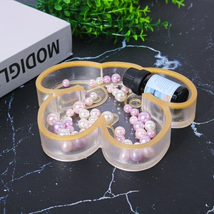 Macro view of cloud-shaped resin tray with gold glitter edges for jewelry storage