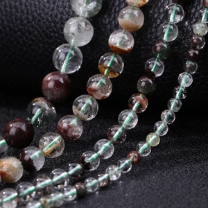Natural green phantom crystal beads set in four different sizes on black leather base
