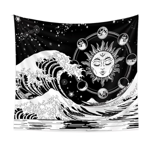 Detailed close-up of bohemian wall tapestry featuring sun, moon phases, and ocean waves