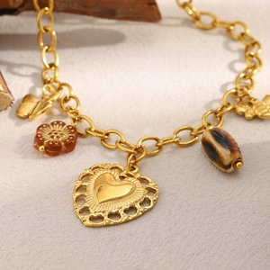 Detailed view of 18K gold-plated O-chain bracelet with heart, butterfly, and shell charms