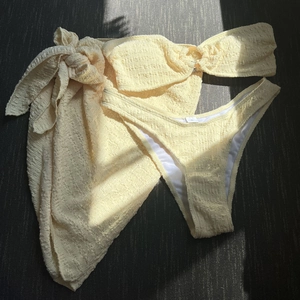 Detailed view of pale yellow textured seersucker bikini set with top and skirt