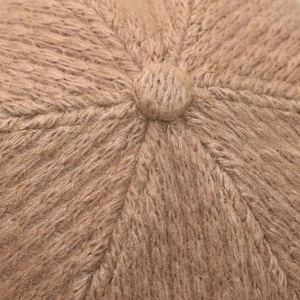 Close-up of a warm camel knitted beanie top with a soft mohair wool blend texture