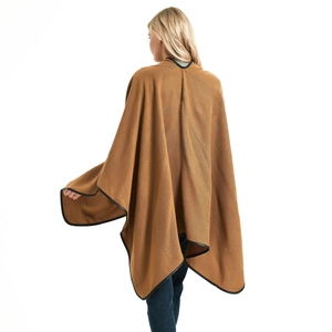 Elegant brown knitted shawl cape for women with black trim edges on a white background