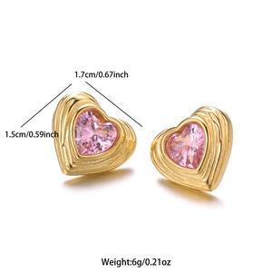 Macro detail of gold heart stud earring with pink gemstone and size measurements
