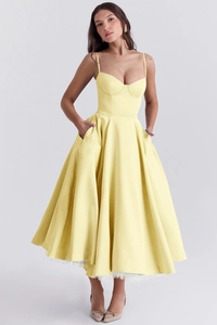 Detail of yellow A-line dress with spaghetti straps and white mesh inner lining