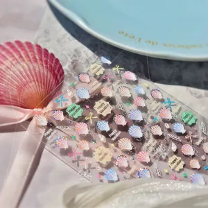 Detail of seashell and starfish nail stickers with holographic foil and glitter finish
