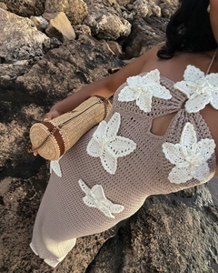 Detail of brown crochet halter dress featuring white floral appliques and knit texture