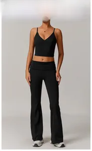 Detail of black V-neck sports bra and high-waisted flared yoga pants on model