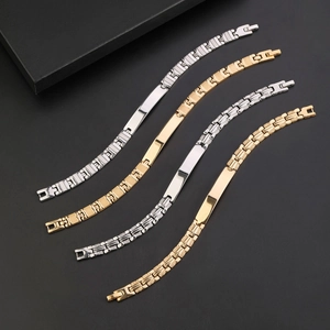 Close-up of gold and silver stainless steel link bracelets with polished ID plates