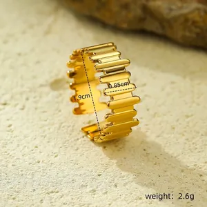 Macro shot of gold-plated corrugated ring showing dimensions and industrial metal texture
