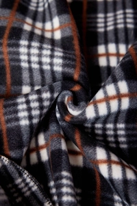 Detailed view of thick fleece knitted cardigan with classic black and brown plaid pattern