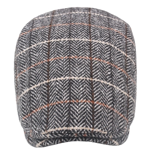 Close-up of grey tweed wool newsboy cap showing detailed herringbone pattern and stitching