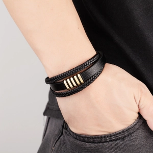 Men's retro multilayer braided leather bracelet with gold metal accents on wrist