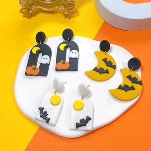 Flat lay of Halloween polymer clay earrings featuring pumpkin, ghost, and bat designs
