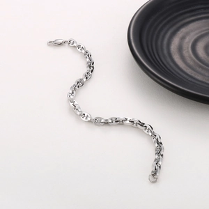Detailed top view of silver-tone pig nose link bracelet in minimalist S-curve layout
