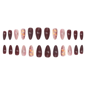 Almond fake nails featuring cherry red tones and hand-painted maple leaf nail art designs