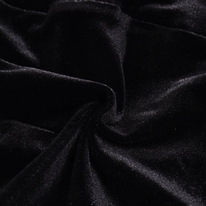 Close-up of black velvet fabric with elastic folds and smooth textured finish