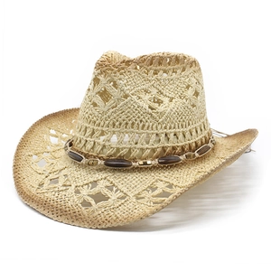 Straw cowboy hat with hollow diamond pattern and ethnic beaded band on white background