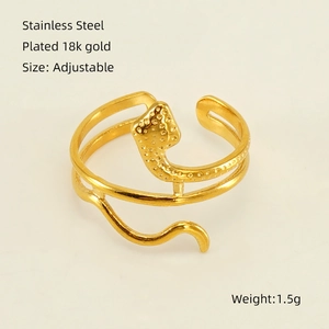 Detail of 18K gold plated snake-shaped adjustable stainless steel ring with grain texture