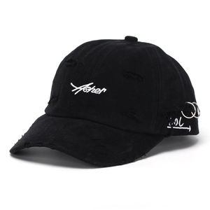 Close-up of distressed black canvas baseball cap with Asher embroidery and metal rings