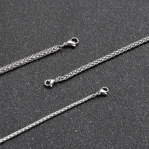 Detailed close-up of three silver spiga wheat chains with secure lobster clasps