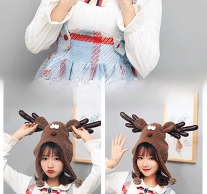 Detailed plush reindeer Christmas hat with leather antlers and cute pom-pom earflaps