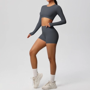 Detail of high-stretch dark grey long sleeve yoga crop top and high waist sports shorts