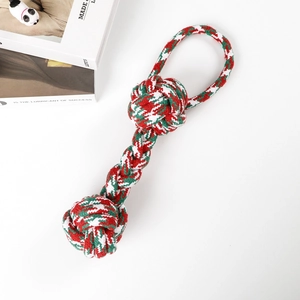 Detailed macro view of red, green and white Christmas braided dog rope toy for pet teething