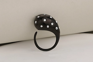 Detail of water-drop stainless steel ring featuring sparkling rhinestones on black finish
