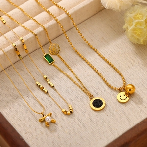 Collection of minimalist gold-plated titanium necklaces with various geometric pendants