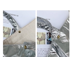 Close-up of silver foil nylon tote bag showing metallic texture and beige canvas lining