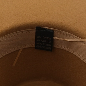 Detail of wool fedora interior showing fabric label with 65% cotton and 35% polyester mix