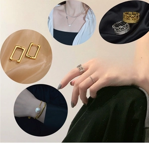 Detail of 14K gold jewelry set featuring double heart pendant and crown ring