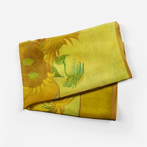 Detail showing the smooth silk texture and Van Gogh sunflowers pattern on a folded scarf