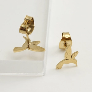 Macro shot of gold hummingbird stud earrings in polished stainless steel