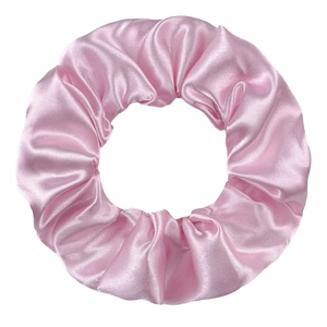 Close-up of a pink satin scrunchie with smooth silk texture and durable elastic band
