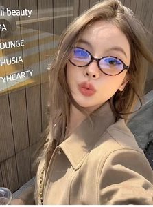 Close-up of retro oval tortoise shell glasses worn by a female model with blue light lenses