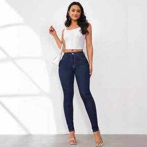 Close-up of dark blue skinny jeans featuring high waist design and white contrast stitching