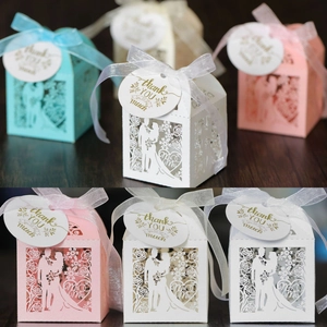 Laser-cut wedding favor boxes with Mr & Mrs hollow design and silk ribbons in three colors