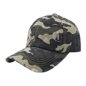 Detail of distressed camouflage baseball cap with vintage worn-out brim and sturdy stitching