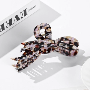 Large tortoiseshell acetate bow hair claw clip with elegant marble pattern for women