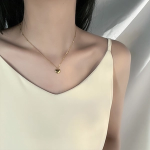 Minimalist gold heart pendant necklace for women worn on neck for a stylish summer look