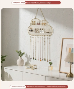 Detailed close-up of cloud-shaped golden jewelry organizer with mesh and ten hanging hooks