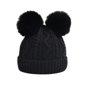 Black cable knit beanie with double faux fur pom poms for winter outdoor warmth
