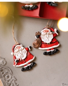 Detailed view of resin Santa Claus figurines with rustic jute hanging ropes for Christmas tree