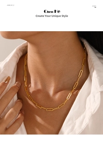 Close-up of golden paperclip chain necklace on a model with white shirt