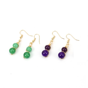 Handmade gold wire earrings with green and purple crystal beads in bohemian style