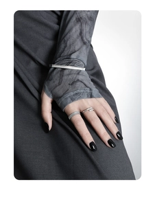 Detail shot of silver S925 sterling silver cuff bracelet and wide textured vertical ring