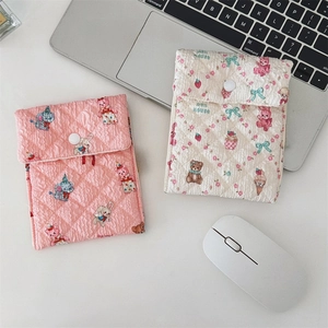 Close-up of quilted cotton sanitary pad pouches with cute animal prints and snap button