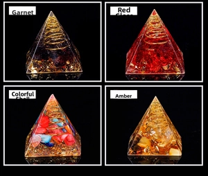 Detailed views of Orgone pyramids with garnet, red glass, shells, and amber resin crystal